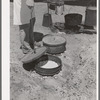 Cook of SMS Ranch making bread in Dutch oven. Near Spur, Texas