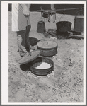 Cook of SMS Ranch making bread in Dutch oven. Near Spur, Texas