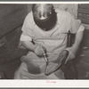 Applying cement to boot before attaching outer sole. Bootmaking shop, Alpine, Texas