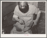 Applying cement to boot before attaching outer sole. Bootmaking shop, Alpine, Texas