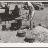 Cook of SMS Ranch making bread in front of chuck wagon. Ranch near Spur, Texas