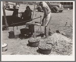 Cook of SMS Ranch making bread in front of chuck wagon. Ranch near Spur, Texas