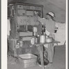 Cook of the SMS Ranch in front of the covered end of the chuck wagon. Ranch near Spur, Texas