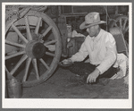 Cowboy eating dinner by the chuck wagon on SMS Ranch near Spur