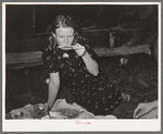 Migrant woman drinking coffee from saucer while camped near Prague, Oklahoma