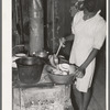 Daughter of Negro agricultural day laborer washing dishes in her home in Muskogee County, Oklahoma