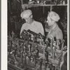 Migrant steeple-jack buying a replacement connecting rod at secondhand automobile parts store. Prague, Oklahoma, Lincoln County