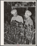 Migrant steeple-jack buying a replacement connecting rod at secondhand automobile parts store. Prague, Oklahoma, Lincoln County