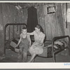 Daughter and son of agricultural day laborer living near Webbers Falls, Oklahoma. The furnishings of this shack were meager and broken and filthy. Muskogee County