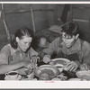 Two agricultural day laborers eating dinner after spending the morning chopping cotton. Beans are the staple fare of these workers. Near Webbers Falls, Oklahoma