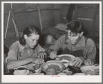 Two agricultural day laborers eating dinner after spending the morning chopping cotton. Beans are the staple fare of these workers. Near Webbers Falls, Oklahoma