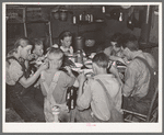 A family of agricultural day laborers eating dinner after a morning spent in chopping cotton. Though the fare of these people consist of the inexpensive and heavy starches, it is usually well prepared