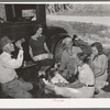 Migrant steeple-jack and his family eating a "bought lunch" by the roadside Near Prague, Oklahoma, Lincoln County