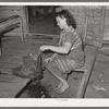 Wife of tenant farmer freezing ice cream on porch of her home near Warner, Oklahoma
