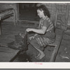 Wife of tenant farmer freezing ice cream on porch of her home near Warner, Oklahoma