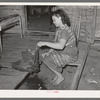 Wife of tenant farmer freezing ice cream on porch of her home near Warner, Oklahoma