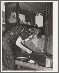 Migrant woman peeling potatoes on running board of car while camped near Prague, Oklahoma. Lincoln County, Oklahoma