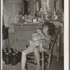 Daughter of white tenant farmer taking care of her baby sister in her home in McIntosh County, Oklahoma