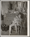 Daughter of white tenant farmer taking care of her baby sister in her home in McIntosh County, Oklahoma