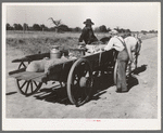 Farmer's wagon loaded with supplies leaving crossroads store in McIntosh County, Oklahoma