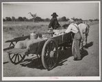 Farmer's wagon loaded with supplies leaving crossroads store in McIntosh County, Oklahoma