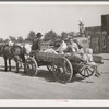 Farmer's wagon loaded with supplies leaving crossroads store in McIntosh County, Oklahoma