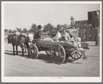 Farmer's wagon loaded with supplies leaving crossroads store in McIntosh County, Oklahoma