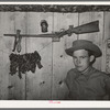 Son of agricultural day laborer with his twenty-two caliber rifle and home-cured tobacco. McIntosh County, Oklahoma