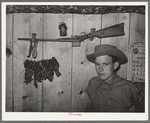 Son of agricultural day laborer with his twenty-two caliber rifle and home-cured tobacco. McIntosh County, Oklahoma