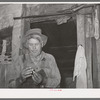Agricultural day laborer in his home near Tullahassee, Oklahoma. Wagoner County