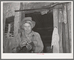 Agricultural day laborer in his home near Tullahassee, Oklahoma. Wagoner County