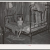 Daughter of agricultural day laborer in bedroom of home in McIntosh County, Oklahoma
