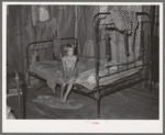 Daughter of agricultural day laborer in bedroom of home in McIntosh County, Oklahoma