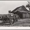 The tractor and home of a man who at one time was a tenant farmer but who is now a day laborer. Wagoner County, Oklahoma