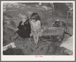 Children of agricultural day laborer sitting on an old automobile seat cushion. On Poteau Creek near Spiro, Oklahoma, Sequoyah County