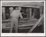 Cleaning screens used in grading at peanut-shelling plant. Comanche, Texas