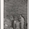 Weighing out feed made from peanut shells and blackstrap molasses. Peanut-shelling plant. Comanche, Texas