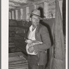 Man with chicken at cooperative poultry house. Brownwood, Texas