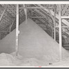 Pile of cotton seed hulls. Cotton seed warehouse, McLennan County, Texas. A new use of these hulls is for flooring in chicken houses. After being used for about six weeks, the hull and manure provide for efficient fertilizer