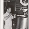 Taking sample of milk from weighing kettle to determine percentage of butter fat. Babcock test. Creamery, San Angelo, Texas