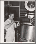 Taking sample of milk from weighing kettle to determine percentage of butter fat. Babcock test. Creamery, San Angelo, Texas