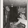 Handling cartons of groceries which have been "shot down the chute." Wholesale grocery, San Angelo, Texas