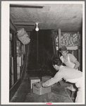 Handling cartons of groceries which have been "shot down the chute." Wholesale grocery, San Angelo, Texas