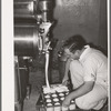 Filling cartons with ice cream mix. Creamery, San Angelo, Texas