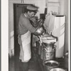 Straining the milk at large dairy in Tom Green County, Texas