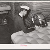 Forming a roll edge on innerspring mattress by special machine. Mattress factory. San Angelo, Texas