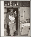 Pomp Hall, Negro tenant farmer, coming in the kitchen door carrying seed and groceries which he bought in Tulsa. Creek County, Oklahoma. See general caption number 23