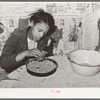 Daughter of Pomp Hall, Negro tenant farmer, picking peas for supper. Creek County, Oklahoma. See general caption number 23