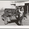 Pomp Hall, Negro tenant farmer, and blacksmith loading Pomp's plow into truck after it has been sharpened. Depew, Oklahoma. See general caption number 23