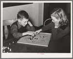 Boy and girl playing Chinese checkers. Eufaula, Oklahoma